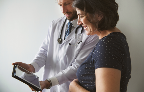 doctor showing tablet to patient