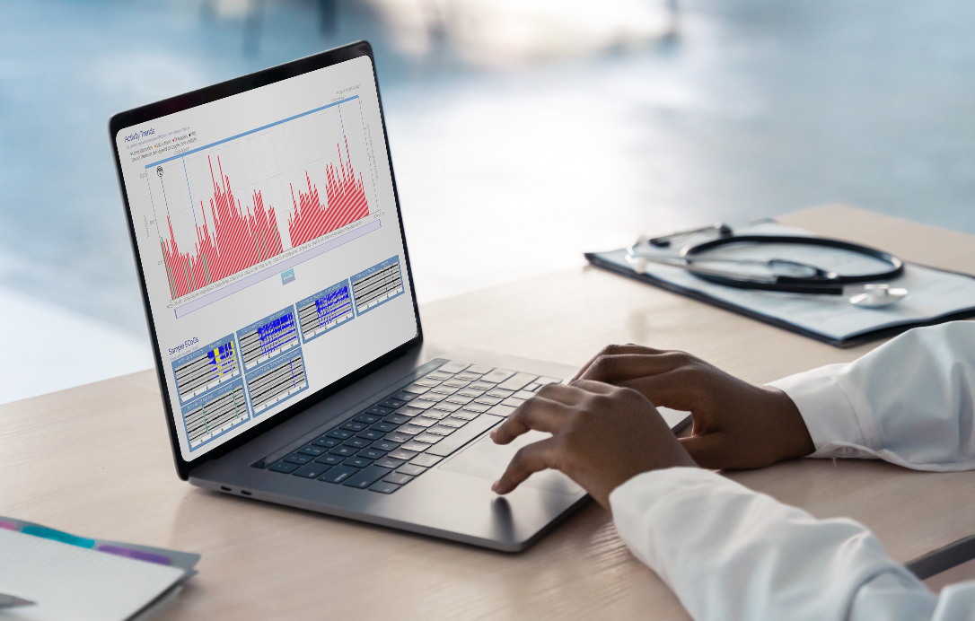 Photo of a clinician's hands on a laptop that is displaying the nSight activity dashboard